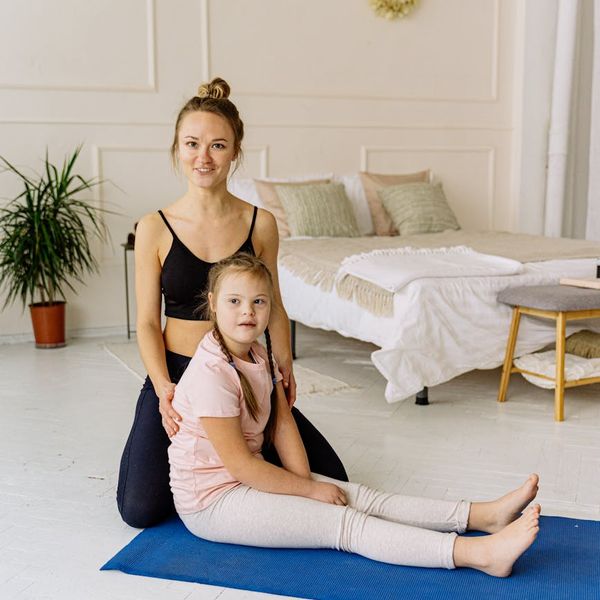 Cozy corner of a room with a yoga mat and a plant.